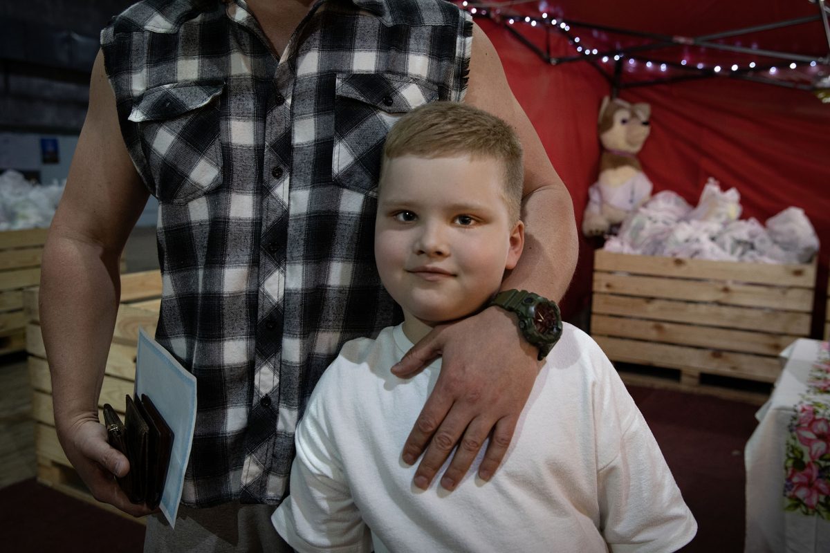 Vlad, 5, picks up a care package with his father at the Moldova for Peace warehouse. 